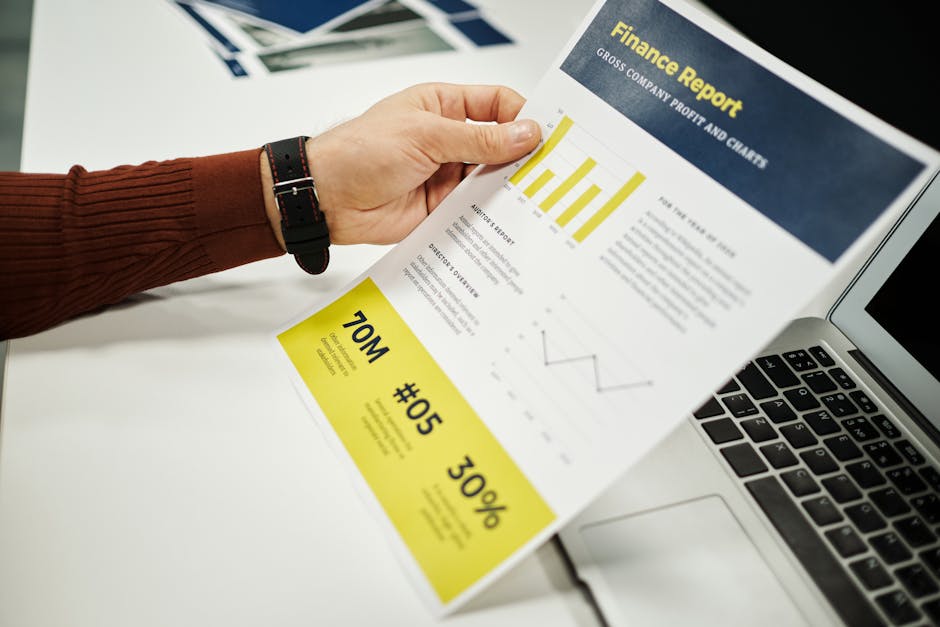Person analyzing finance report with graphs at desk, ideal for business concepts.